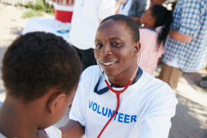 Volunteer Phlebotomist Examining a Patient